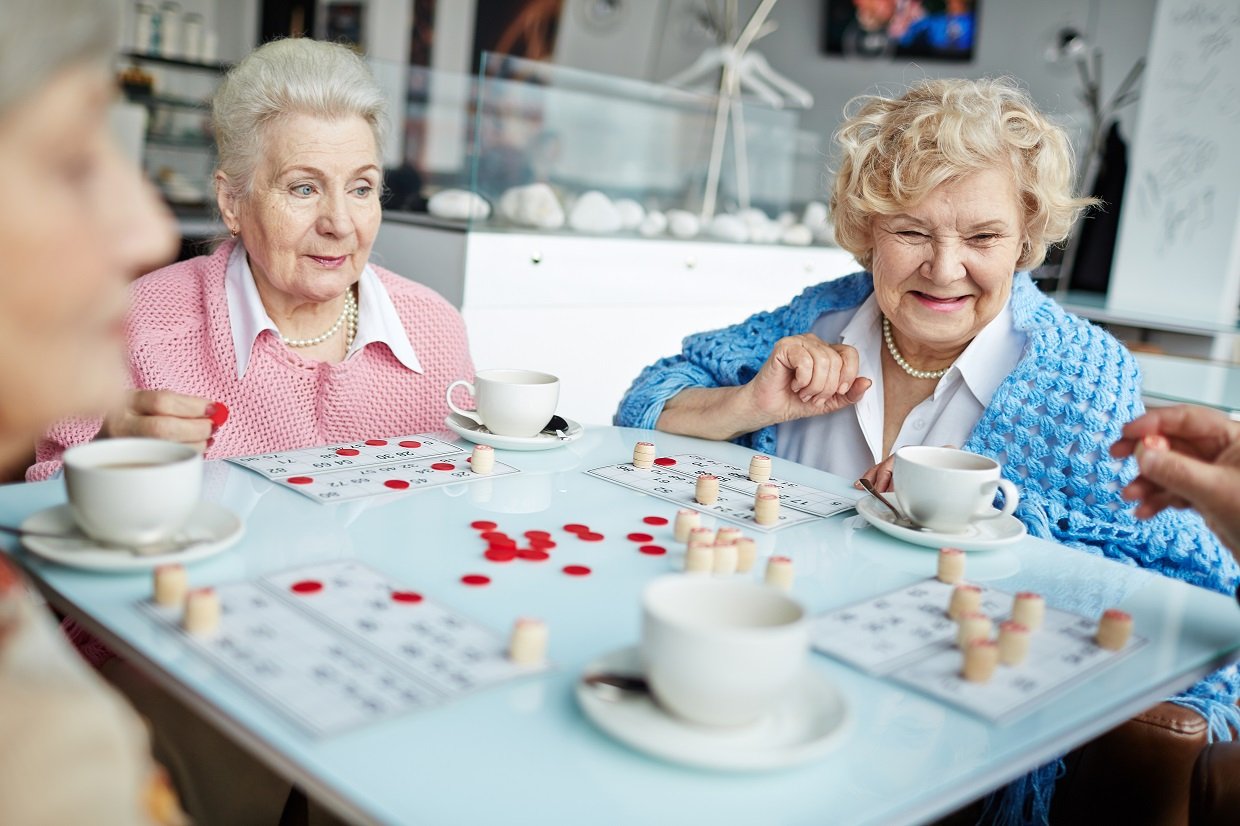 Seniors playing lotto at leisure in cafe