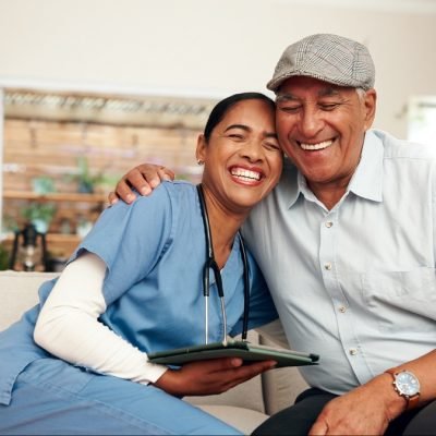 Hug, nurse and senior man with tablet in retirement home for examination, wellness and elderly care.
